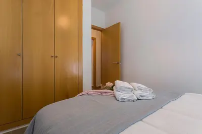 a bedroom with a bed with towels on it at Cruz Vieja Centrico 3 Rooms in Jerez de la Frontera