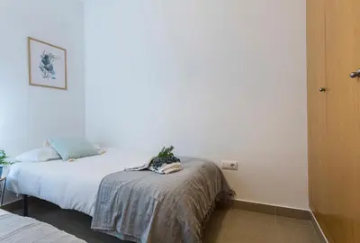 a bedroom with a bed with a plant on it at Cruz Vieja Centrico 3 Rooms in Jerez de la Frontera