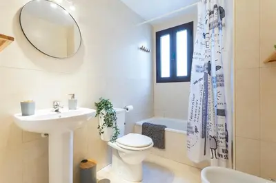 a bathroom with a sink and a toilet and a mirror at Cruz Vieja Centrico 3 Rooms in Jerez de la Frontera