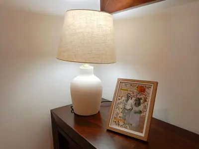 a white vase sitting on a table next to a picture at Dúplex Apartment Sol de la Plazuela in Jerez de la Frontera