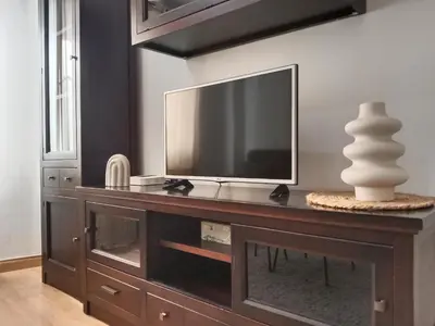 a entertainment center with a television on top of it at Dúplex Apartment Sol de la Plazuela in Jerez de la Frontera