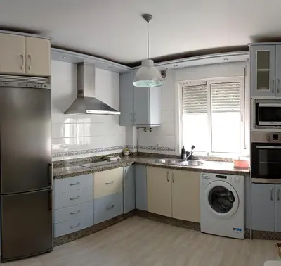 a kitchen with white cabinets and a washer and dryer at Dúplex Apartment Sol de la Plazuela in Jerez de la Frontera