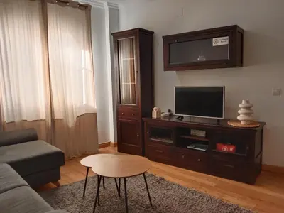 a living room with a couch and a tv at Dúplex Apartment Sol de la Plazuela in Jerez de la Frontera