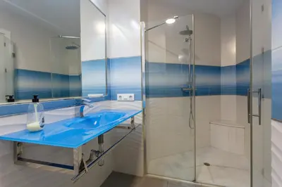 a bathroom with a blue sink and a shower at PUERTA del MAR Family Home by Cadiz4Rentals in Cádiz