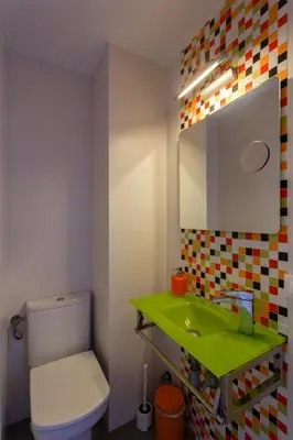 a bathroom with a green sink and a toilet at PUERTA del MAR Family Home by Cadiz4Rentals in Cádiz