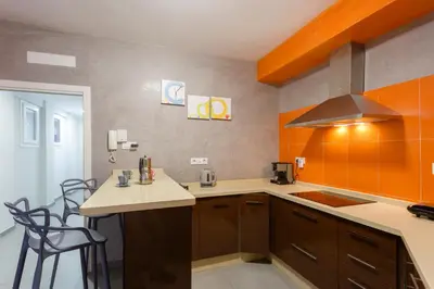 a kitchen with a counter and a stove top oven at PUERTA del MAR Family Home by Cadiz4Rentals in Cádiz