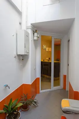 a bathroom with an orange and white wall at PUERTA del MAR Family Home by Cadiz4Rentals in Cádiz