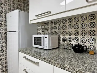a kitchen with a white microwave on a counter at Apartamento Larga 65 - Ole Solutions in Jerez de la Frontera