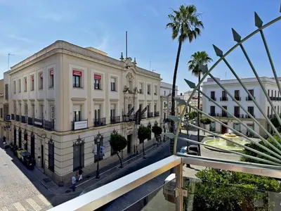 a view of a building in a city with palm trees at Apartamento Larga 65 - Ole Solutions in Jerez de la Frontera