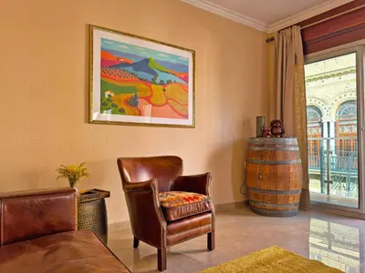 a living room with a couch and a chair and a barrel at Apartamento Larga 65 - Ole Solutions in Jerez de la Frontera