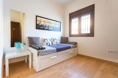 a bedroom with a bed and a window at VILLA DE LUJO CLIMATIZADA. PISCINA Y JARDIN PRIVADO in Chiclana de la Frontera