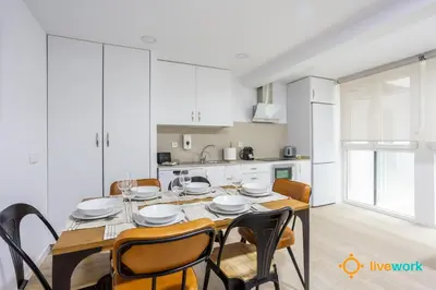 a kitchen and dining room with a table and chairs at Travelers Dream by LiveWork in Cádiz