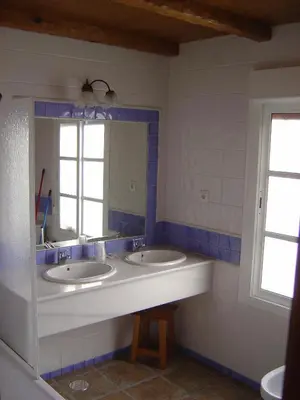 a bathroom with two sinks and a large mirror at Hacienda los Majadales in Conil de la Frontera