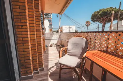 a chair sitting on a balcony with a table at Baylight Retreat Apartment in El Puerto de Santa María
