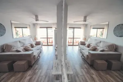 a large living room with couches and wooden floors at Baylight Retreat Apartment in El Puerto de Santa María