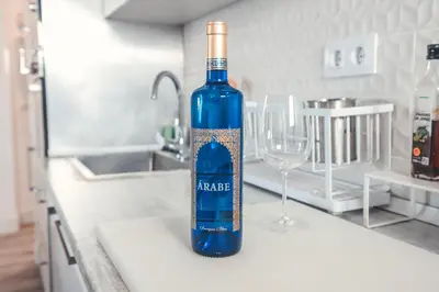 a blue bottle of wine sitting on a kitchen counter at Baylight Retreat Apartment in El Puerto de Santa María