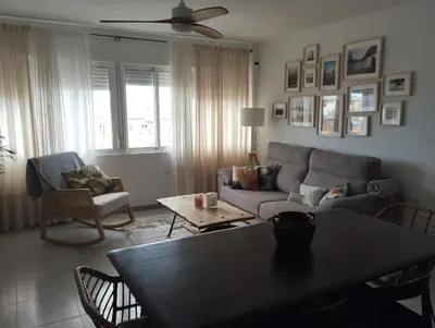 a living room with a couch and a table at LA PONDEROSA BEACH in Sanlúcar de Barrameda