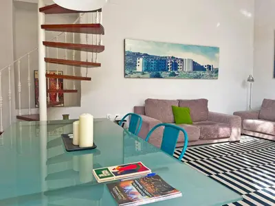 a living room with a glass table and a couch at Apartamento Villamarta - Ole Solutions in Jerez de la Frontera