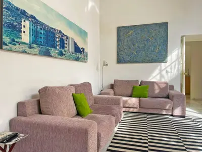 a living room with two couches and green pillows at Apartamento Villamarta - Ole Solutions in Jerez de la Frontera