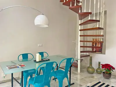 a dining room with a blue table and blue chairs at Apartamento Villamarta - Ole Solutions in Jerez de la Frontera