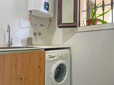 a washing machine in a kitchen next to a sink at Apartamento Villamarta - Ole Solutions in Jerez de la Frontera