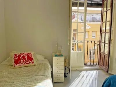 a bedroom with a bed and a large window at Apartamento Villamarta - Ole Solutions in Jerez de la Frontera