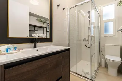 a bathroom with a sink and a shower at El Balcón de la Bodega - Luxurious apartment in Jerez with gym in Jerez de la Frontera
