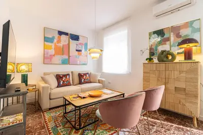 a living room with a couch and a table at El Balcón de la Bodega - Luxurious apartment in Jerez with gym in Jerez de la Frontera