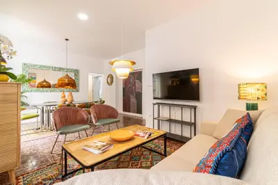 a living room with a couch and a table at El Balcón de la Bodega - Luxurious apartment in Jerez with gym in Jerez de la Frontera