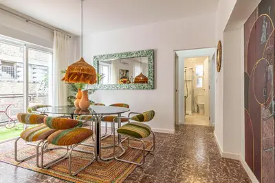 a dining room with a glass table and chairs at El Balcón de la Bodega - Luxurious apartment in Jerez with gym in Jerez de la Frontera
