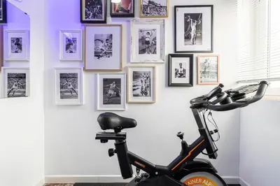 a bike is parked in front of a wall with pictures at El Balcón de la Bodega - Luxurious apartment in Jerez with gym in Jerez de la Frontera