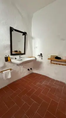 a bathroom with a sink and a mirror on the wall at Apartamentos Jerez Siglo XIX in Jerez de la Frontera