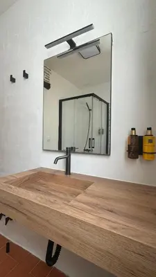 a bathroom with a sink and a mirror at Apartamentos Jerez Siglo XIX in Jerez de la Frontera