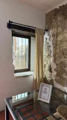 a glass table in a room with a window at Apartamentos Jerez Siglo XIX in Jerez de la Frontera