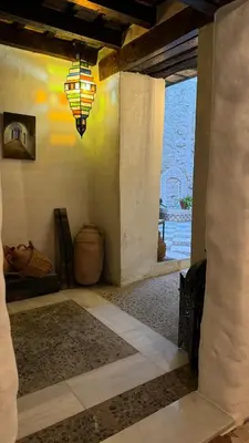 a room with a large window and a chandelier at Apartamentos Jerez Siglo XIX in Jerez de la Frontera