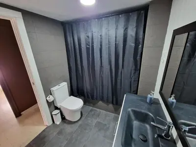 a bathroom with a sink and a toilet and a shower at Piso las marismas in Chiclana de la Frontera