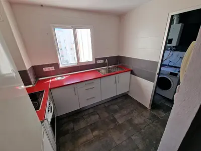 a small kitchen with a sink and a window at Piso las marismas in Chiclana de la Frontera