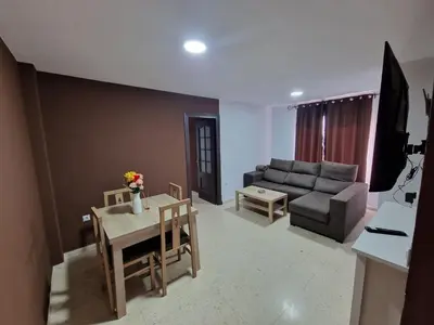 a living room with a couch and a table at Piso las marismas in Chiclana de la Frontera