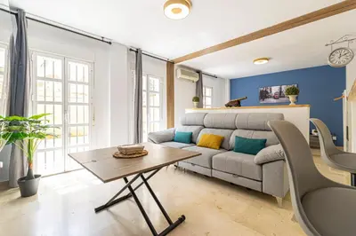 a living room with a couch and a table at Sherry Suite Apartment - City Center in Jerez de la Frontera