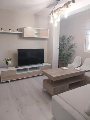 a living room with a large flat screen tv at PLAYA LAS PILETAS-CALZADA in Sanlúcar de Barrameda