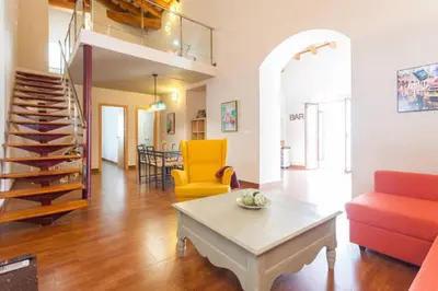 a living room with a couch and a table at Apartamentos Sherry Center in Jerez de la Frontera