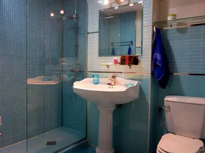a bathroom with a sink and a shower and a toilet at Ático con impresionantes vistas in El Puerto de Santa María