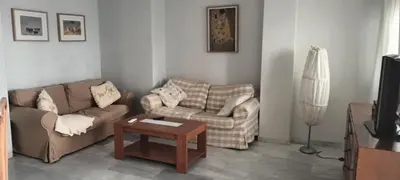 a living room with two couches and a coffee table at Ático con impresionantes vistas in El Puerto de Santa María