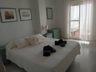 a bedroom with a bed with two hats on it at Ático con impresionantes vistas in El Puerto de Santa María