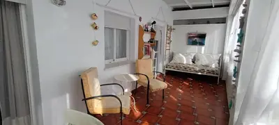 a room with chairs and a table and a bed at Ático con impresionantes vistas in El Puerto de Santa María
