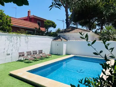 a swimming pool in the yard of a house at Brisa Home in Chiclana de la Frontera