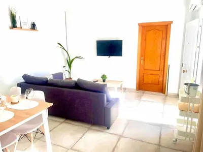a living room with a purple couch and a table at Brisa Home in Chiclana de la Frontera