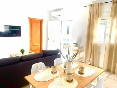 a living room with a table and a couch at Brisa Home in Chiclana de la Frontera