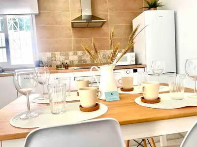 a kitchen with a table with wine glasses on it at Brisa Home in Chiclana de la Frontera