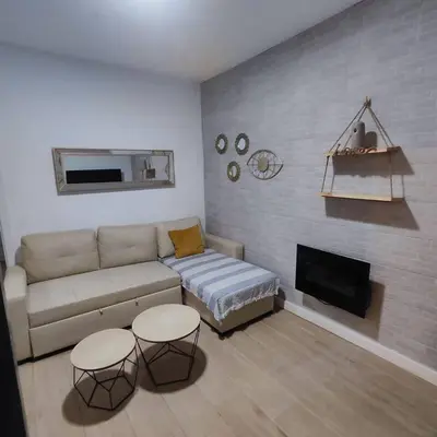 a living room with a couch and a fireplace at Jacuzzi Amazonas Relax en el Corazón del Puerto in El Puerto de Santa María